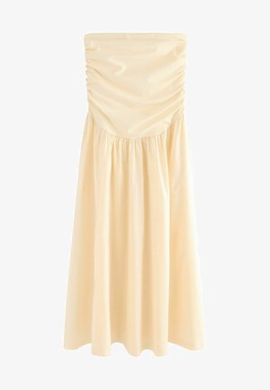 Gaiši beļģu bezvīļu kleita ar drapētiem augšdaļiem un plūstošu, sakopoto svārku. Gluda auduma ar maigu tekstūru. Nav redzamu rakstu vai akcentu.