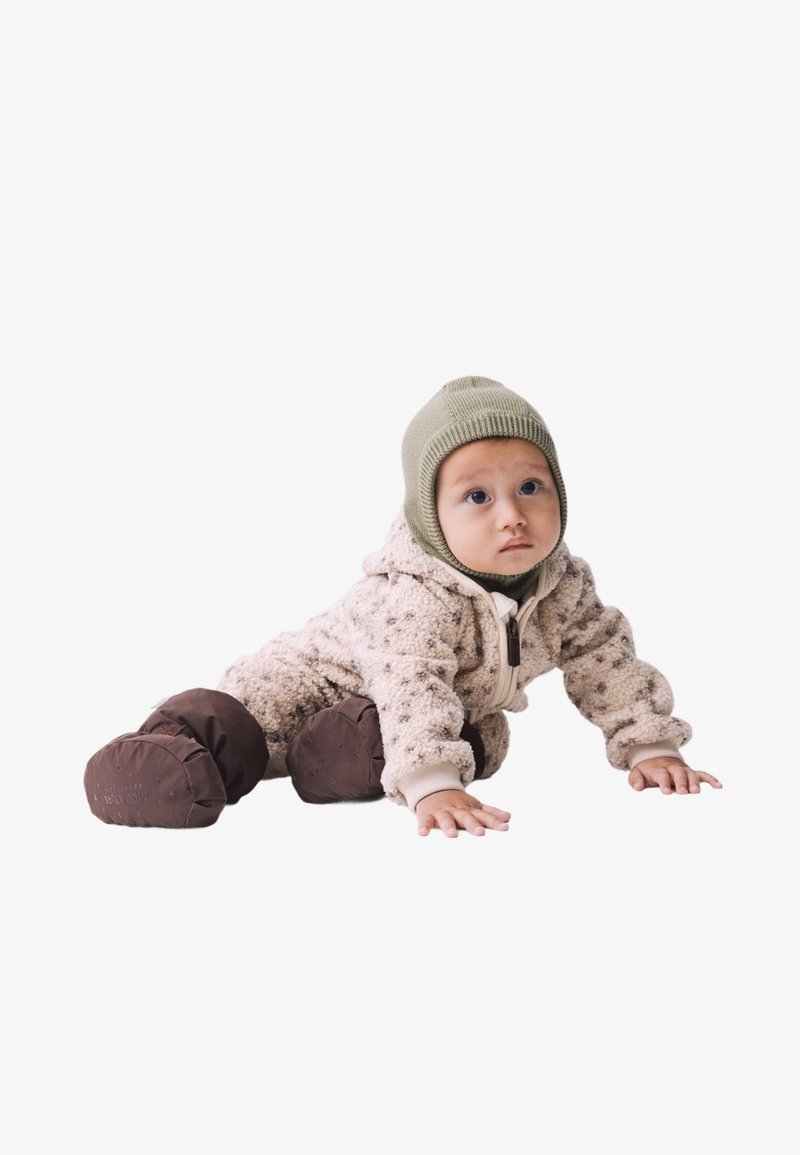 Cremefarbener Fleece-Babyanzug mit Kapuze, braunen unteren Teilen und pinken Akzenten. Das Baby krabbelt und trägt eine grüne Strickmütze.
