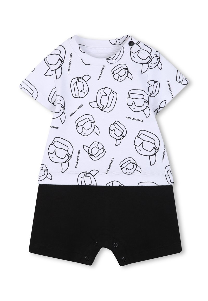 Salopetă cu mâneci scurte, albă, cu imprimeu negru cu față de desen animat, prevăzută cu capse la baza și pantaloni scurți contrastanți negri. Material din bumbac.