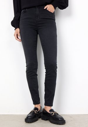 Jeans skinny neri, a vita alta, con design a cinque tasche. Realizzati in denim, con una texture liscia e una vestibilità slim, abbinati a mocassini neri.