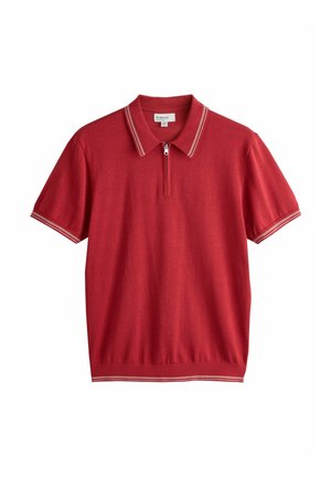 Rød polo t-shirt med korte ærmer med hvidstribet krave, manchetter og kant, med en lynlås foran i stedet for knapper.