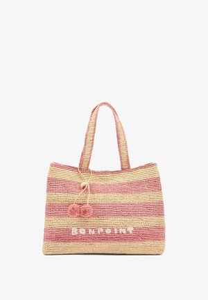 Sac en paille tressée avec des rayures horizontales roses et beiges. Il comprend deux poignées supérieures et des pompons décoratifs. Texte "BONPOINT" à l'avant.