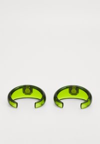 Green translucent resin cuffs with a wide, open design and smooth texture. Each has a rounded edge and a slightly thicker base.