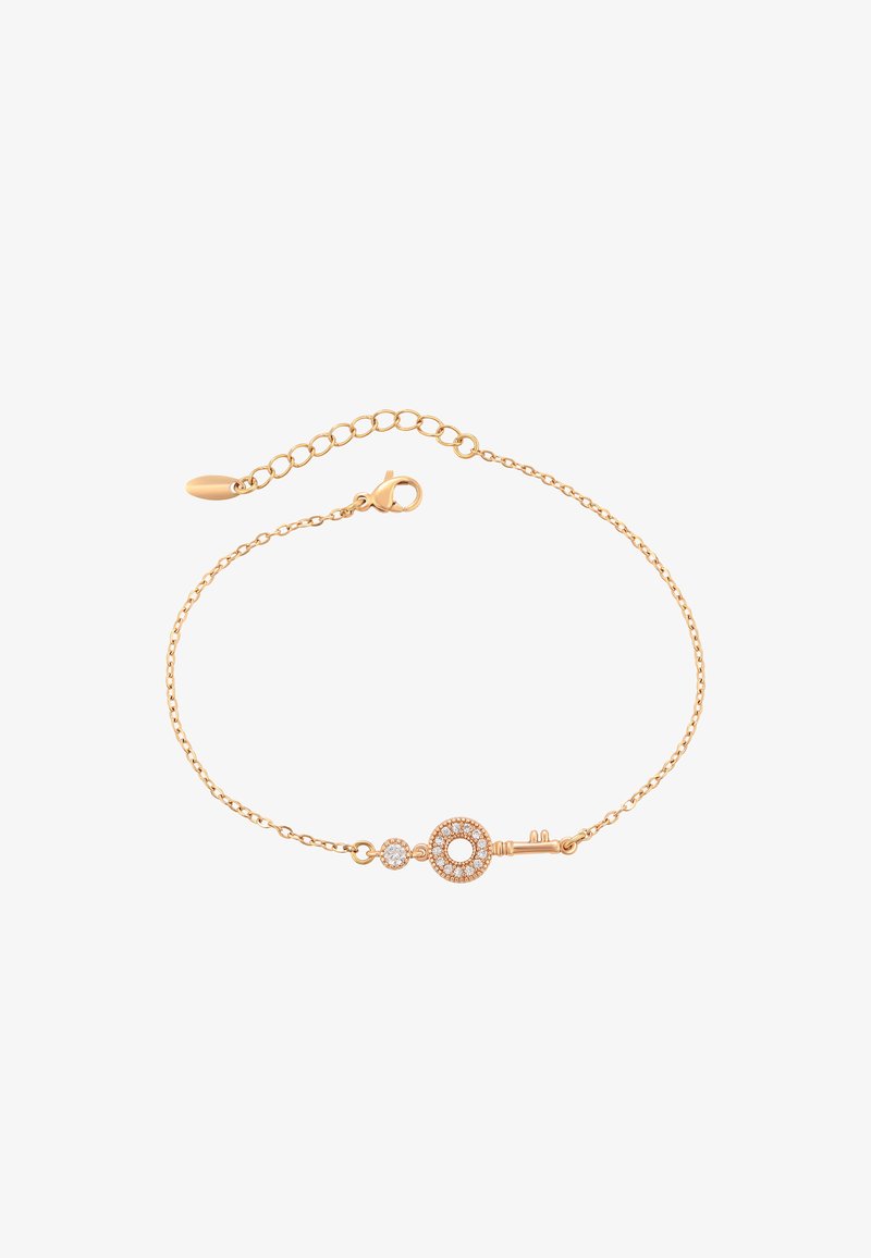 Bracciale in catena dorata con un charm a forma di chiave, accentato da un elemento circolare e un dettaglio in cristallo, che mette in mostra un design delicato e una texture raffinata.
