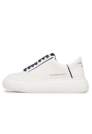 White leather sneaker with blue satin laces, a padded collar, metallic gold accents, and a thick white rubber sole. Features brand name “ALEXANDER SMITH.”