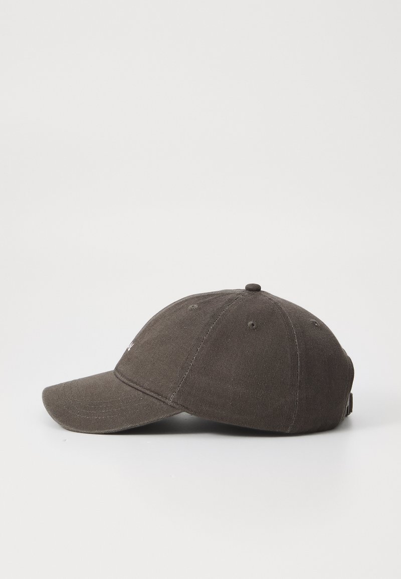 Dark brown cotton baseball cap with a rounded crown, curved visor, and adjustable strap at the back. Textured fabric with small stitching details.