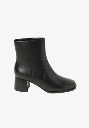 Black leather ankle boot with a square toe, mid-height block heel, and sleek sides. Features a zipper closure for easy access.