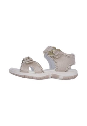 Sandalo da bambino in tessuto beige con cinturini a strappo, suola bianca imbottita e fiocco dorato decorativo sulla cinghia alla caviglia.