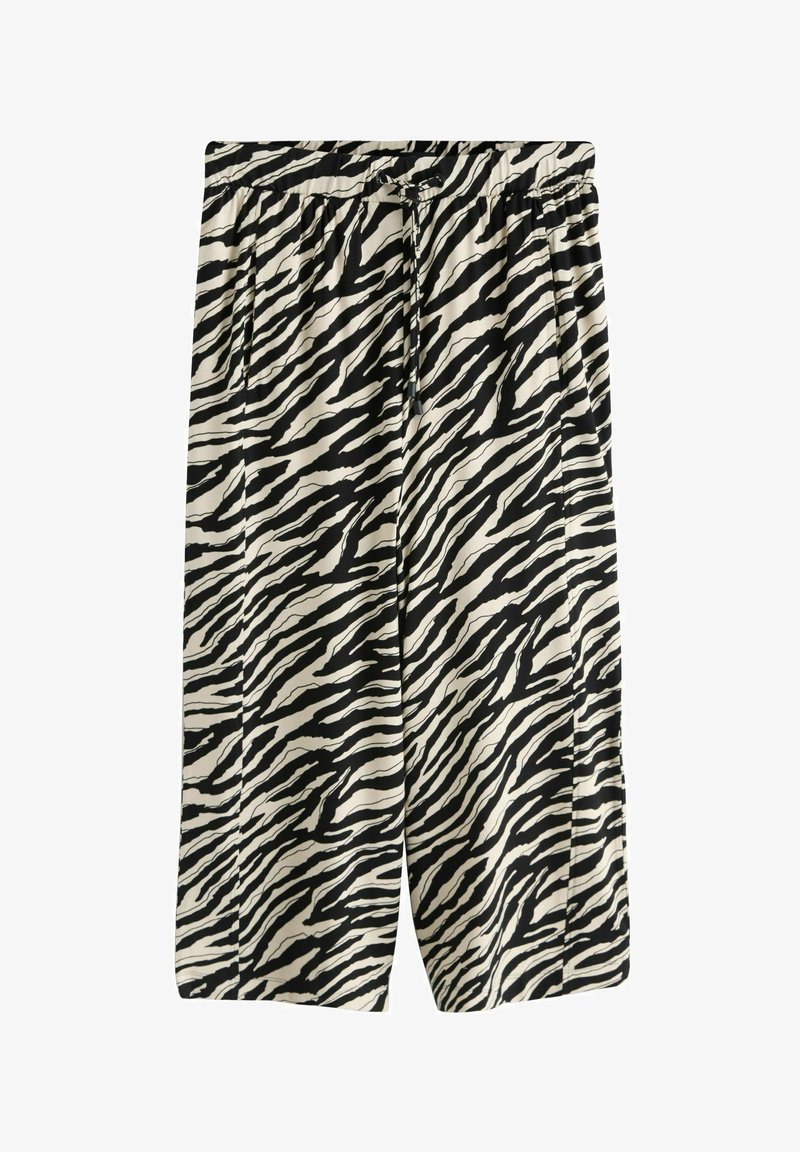 Pantalon large et court à rayures zèbre noires et blanches, avec taille élastique et cordon de serrage.