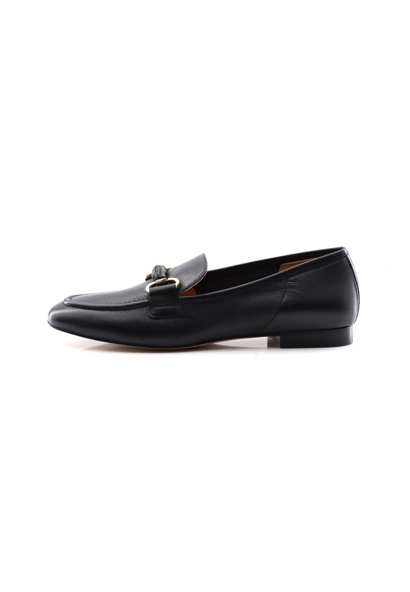 Black leather loafer with a rounded toe, smooth texture, flat heel, and two gold-tone decorative buckles on the front strap.