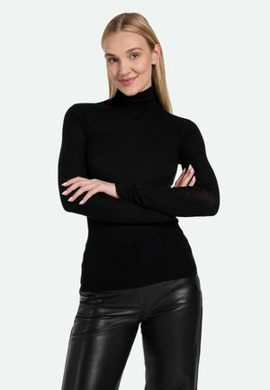 Black turtleneck top made of soft fabric, fitted design with long sleeves, paired with black leather pants.