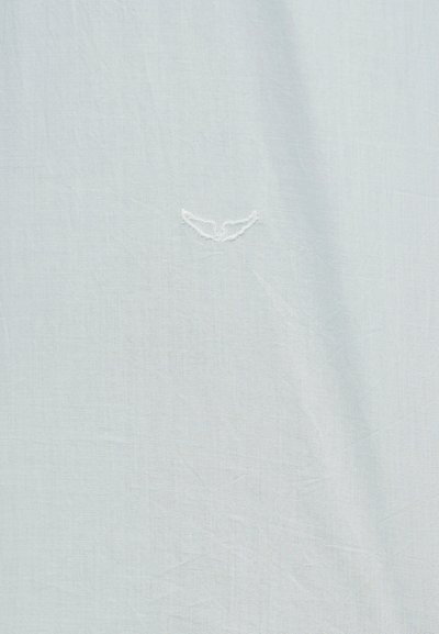 Ανοιχτό γαλάζιο ύφασμα με διακριτικό λευκό κεντημένο λογότυπο πουλιού στο κέντρο του υλικού.