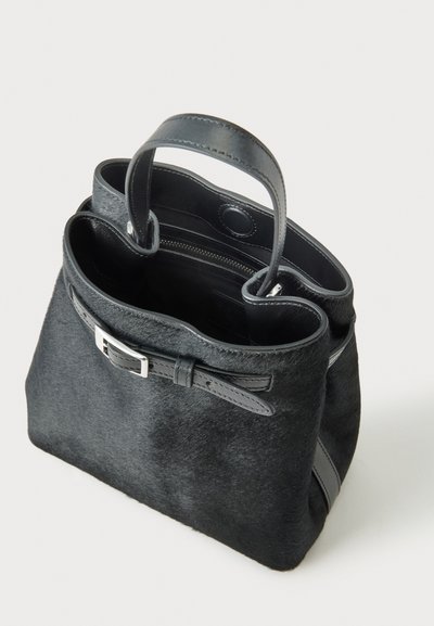 Sac à main noir texturé avec de courtes poignées en cuir, une lanière avant à boucle et un compartiment intérieur zippé.