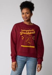 Bordeaux sweatshirt met een relaxed fit, voorzien van een gele grafische afbeelding van een UFO en spek, met textuurstof en geribbelde manchetten.