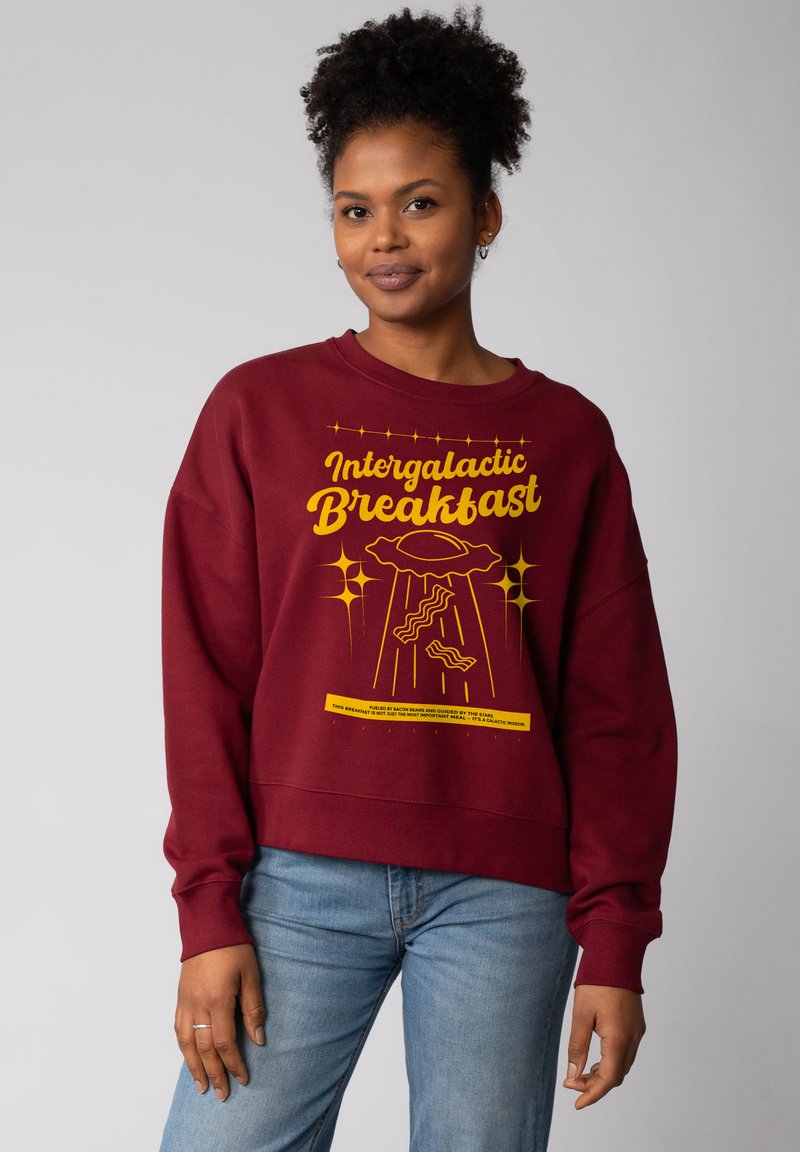 Bordeaux sweatshirt met een relaxed fit, voorzien van een gele grafische afbeelding van een UFO en spek, met textuurstof en geribbelde manchetten.
