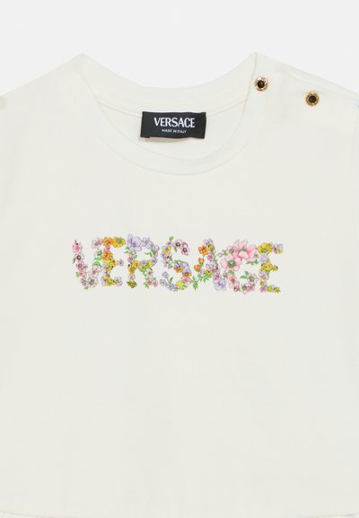 Λευκό βαμβακερό T-shirt με πολύχρωμα ανθικά γράμματα "VERSACE". Περ ιλαμβάνει χρυσές μεταλλικές λεπτομέρειες κοντά στον ώμο. Μαλακή υφή.
