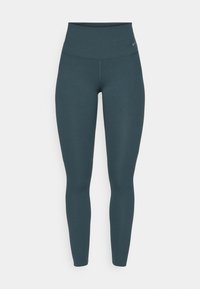 Ciemnoniebieskie legginsy z podwyższonym stanem o dopasowanym kroju, wykonane z gładkiego, elastycznego materiału. Posiadają minimalne logo na pasku.