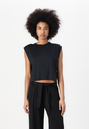 Black cropped t-shirt with short, structured sleeves. Made from a smooth fabric, it features a round neckline and a relaxed fit.