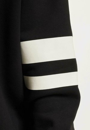 Black sweatshirt with a smooth texture featuring three white horizontal stripes on the right sleeve.