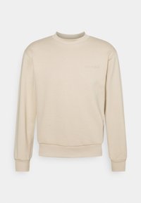 Beige sweatshirt med rund hals, långa ärmar, ribbade muddar och midjeresår. Har subtil prägling med varumärket på framsidan. Slät textur.