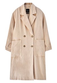Abrigo de lino beige de doble botonadura con grandes bolsillos frontales, solapas muesca y un corte relajado. Tejido texturizado con botones marrones.