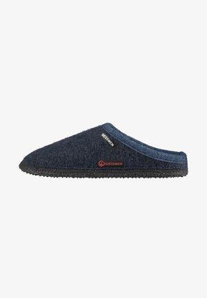 Dark blue felt slipper with a textured surface, rounded toe, black rubber sole, and a small brand tag featuring red accents.