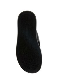 Svart gummisula med texturerad yta, med rundad form och en tydligt synlig varumärkesetikett nära hälen.