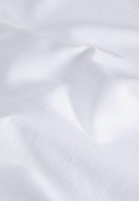 White woven fabric with a smooth texture, featuring subtle ribbed patterns and soft folds, reflecting light softly across the surface.
