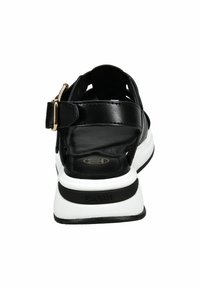 Black leather sandal with an open design, gold buckle accent, and white midsole. Features a textured black insole and logo detail.