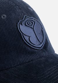 Navy corduroy cap featuring a textured embroidered rose emblem in a similar dark blue shade. Structured design with subtle detailing.