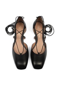 Black leather shoes with a square toe. Features crisscrossing straps and a smooth texture. Includes long black laces.