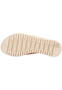Shoe sole with a textured pattern, featuring ridges and heel details. Color is cream with subtle embossed designs on the surface.