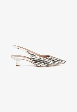 White and black slingback shoe with a pointed toe, textured upper, and a low, flared heel. Features adjustable ankle strap for fit.