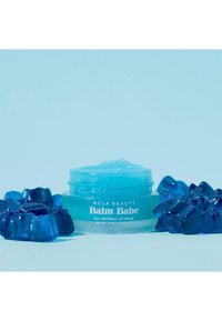 Light blue jar of NCLA Beauty Balm Babe lip balm, with a translucent lid, surrounded by blue gummy bear shapes, on a soft blue background.