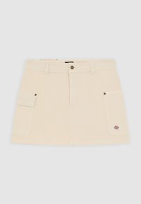 Knälång kjol i ljus beige bomull med knappstängning fram, två sidofickor och en liten logotypapplikation på den högra fickan.