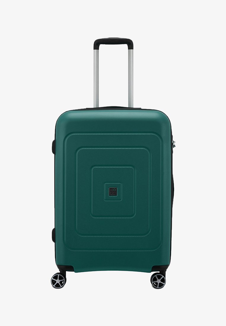 Valise rigide vert foncé avec poignée télescopique et quatre roues tournantes, panneau avant carré et fermeture éclair latérale.