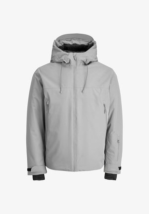 Lys grå, isoleret jakke med hætte, frontlynlås og sidelommer med lynlås. Har justerbare ærmer og en glat, vandafvisende overflade.