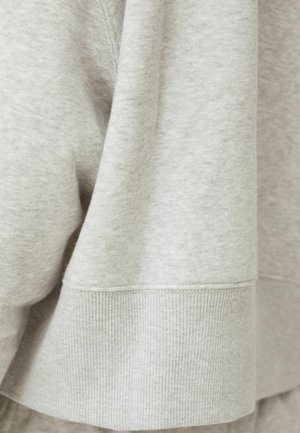 Light gray sweatshirt made of soft cotton blend fabric. Features a ribbed cuff and a smooth texture with minimal detailing.
