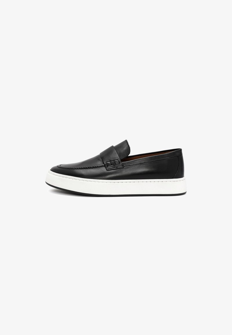Black leather slip-on shoe with a white rubber sole, rounded toe, and subtle stitching details on the upper.