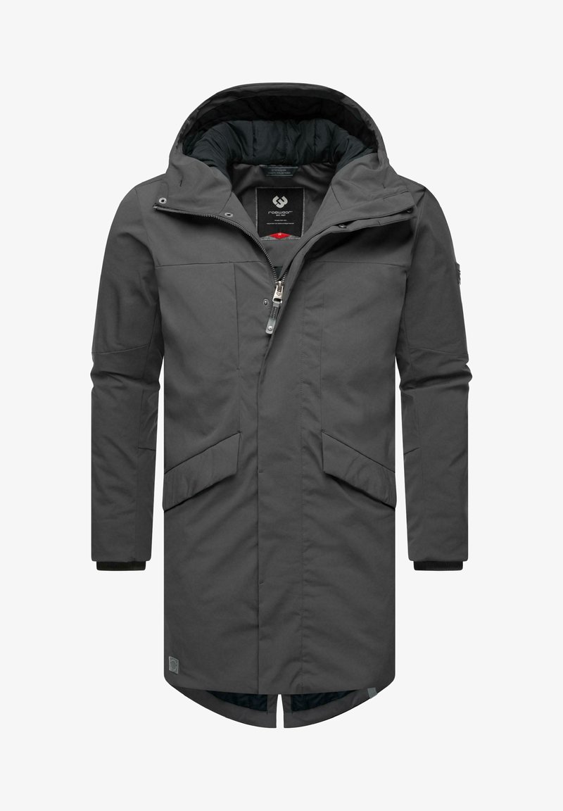 Tumma harmaa, pitkä parka, joka on valmistettu tekstuurittomasta kankaasta. Varustettu irrotettavalla hupulla, edessä vetoketjulla, kahdella suurilla sivutaskulla ja ribbireunuksilla.