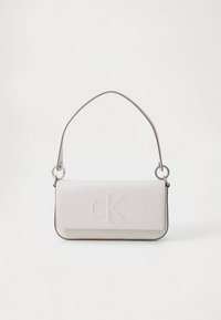 White leather handbag with a rectangular shape, embossed 'cK' logo, and a thin, adjustable shoulder strap with silver hardware accents.