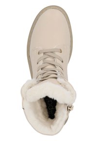 Bottine beige à lacets avec un doux intérieur en fausse fourrure blanche. Présente une toe arrondie et un design cousu le long du bord de la semelle.