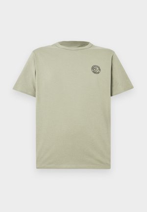 Light olive green short-sleeve cotton T-shirt with small black circular logo on left chest, crew neck, and plain design.