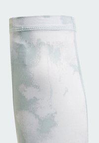 Light blue athletic leggings with a cloud-like pattern, made from stretchy fabric. Features "CUlMNA COOL" branding near the waistband.