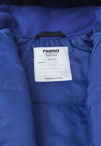 Unutrašnjost plave izolirane jakne s glatkim materijalom, oznakom s "reima", veličinom 104/4T i porukom koja potiče da se predaje dalje.