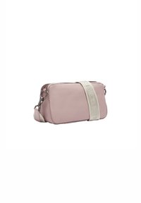 Pink leather crossbody bag with a textured surface, silver hardware, and a cream strap featuring embossed lettering. Zipper closure at the top.
