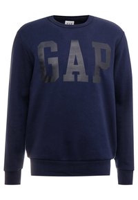 Námořnická modrá mikina s dlouhými rukávy, kulatým výstřihem a lesklým černým logem 'GAP' vpředu. Měkký materiál, žebrované cuffs a lem.