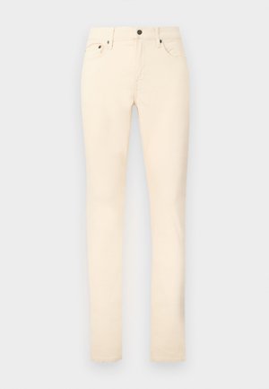 Beżowe spodnie o dopasowanym kroju z przednimi i monetykowymi kieszeniami, szlufkami na pasek i zapięciem na guzik.