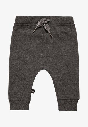 Pantalon pour bébé gris foncé avec taille à cordon tricoté et poignets côtelés, comportant une petite étiquette noire avec une étoile sur la jambe gauche.