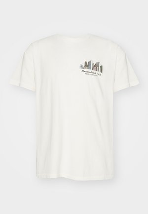 Roomkleurig katoenen T-shirt met een losse pasvorm, voorzien van een afbeelding van stadsgebouwen en de tekst "Abercrombie & Fitch New York City."